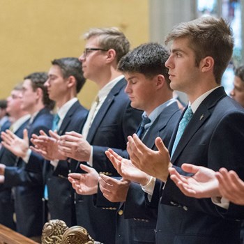 students in prayer at the mass of the holy spirit